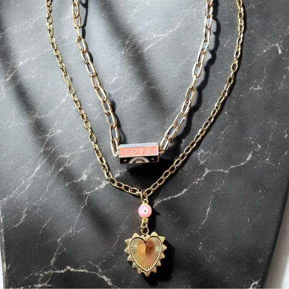 Gold toned chains with black, white, gold, and pastel pink enamel charms. - Picture 13 of 17